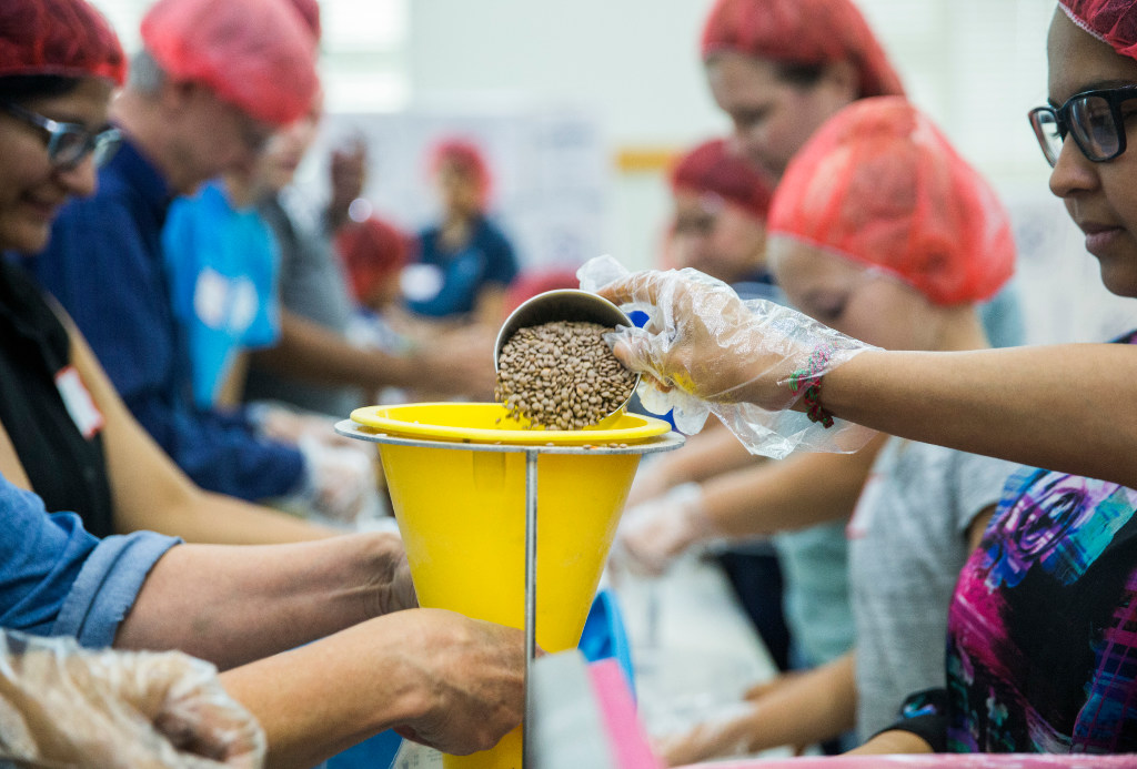 Members of the Ismaili Muslim community and other volunteers, in partnership with Feeding Children Everywhere, pack 100,000 healthy meals Sunday at Ismaili Jamatkhana and Center in Carrollton. The meals will be delivered to victims of Hurricane Harvey.