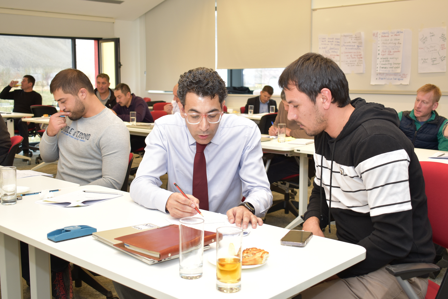 A participant discussing his SMART goals with Sahib Karim during the session at Khorog Campus, Tajikistan