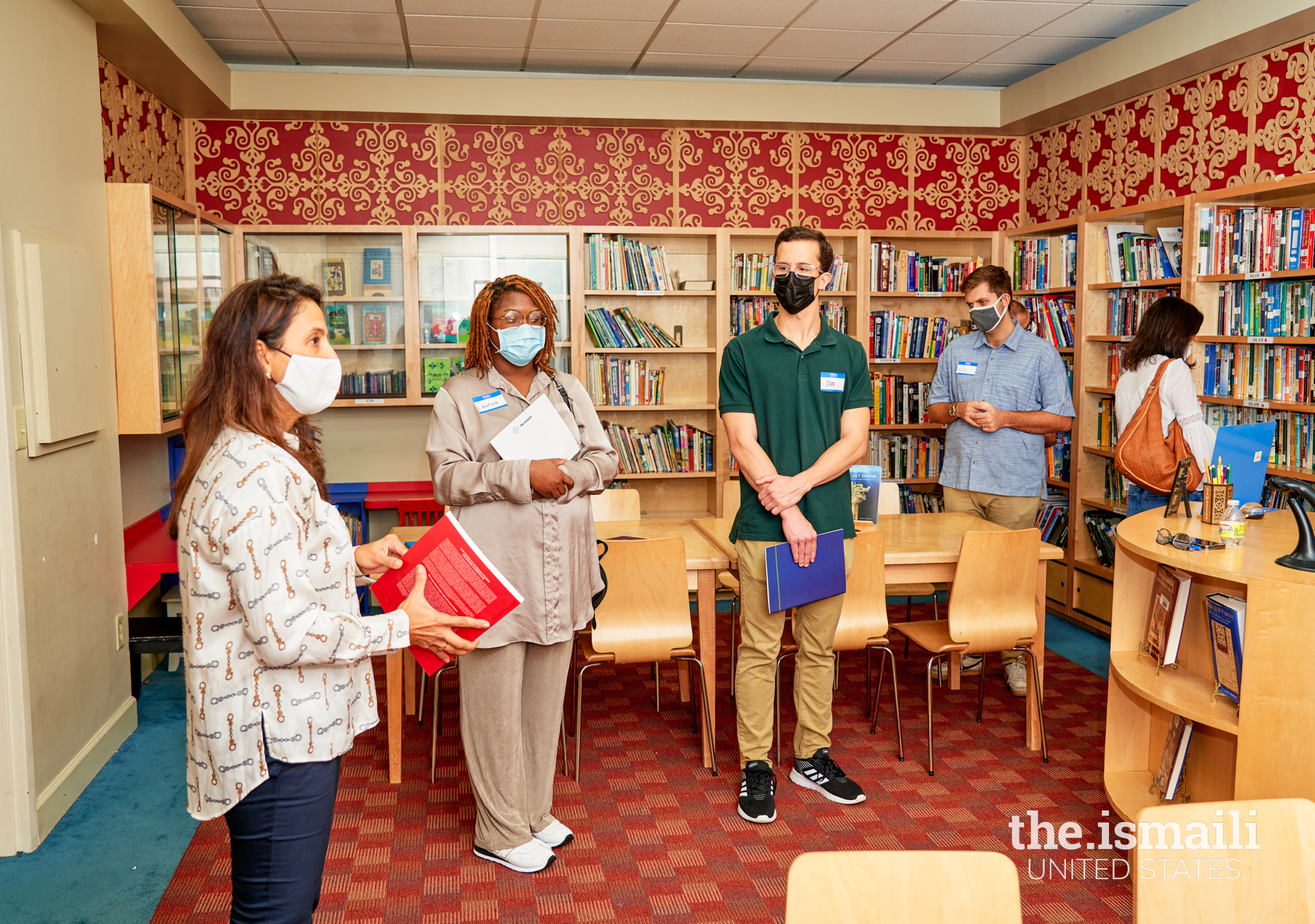 Attendees explore and peruse the literature inside the library of the Ismaili Jamatkhana.