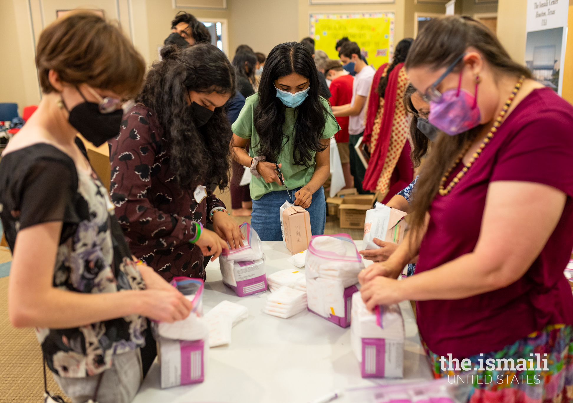 Ismaili CIVIC and Interfaith Atlanta members work together to compile care packages for Afghan refugees as a service activity at the Atlanta Headquarters Ismaili Jamatkhana.