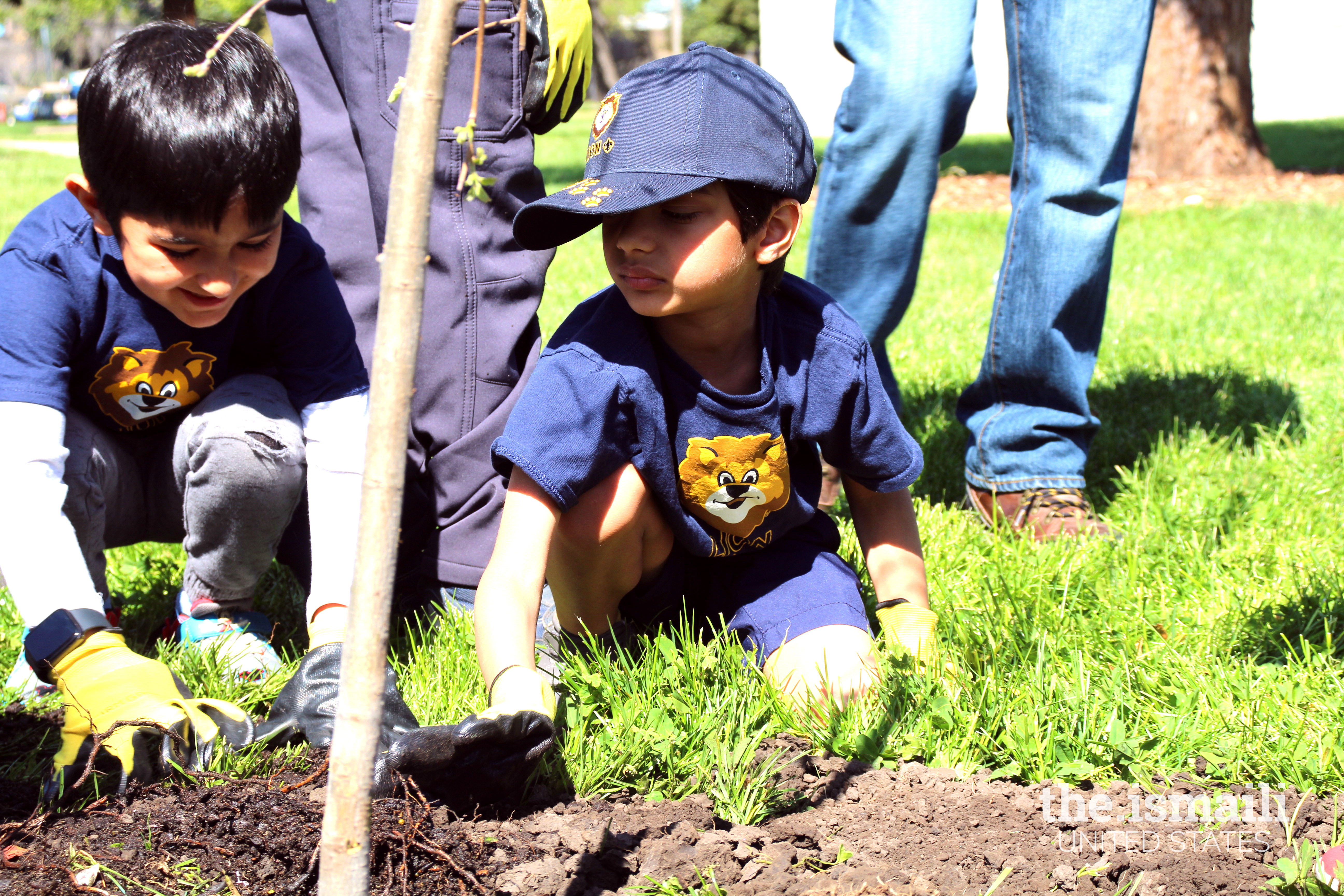 Lion Scouts Sinan Damani and Liam Manji are pleased after planting their first tree.