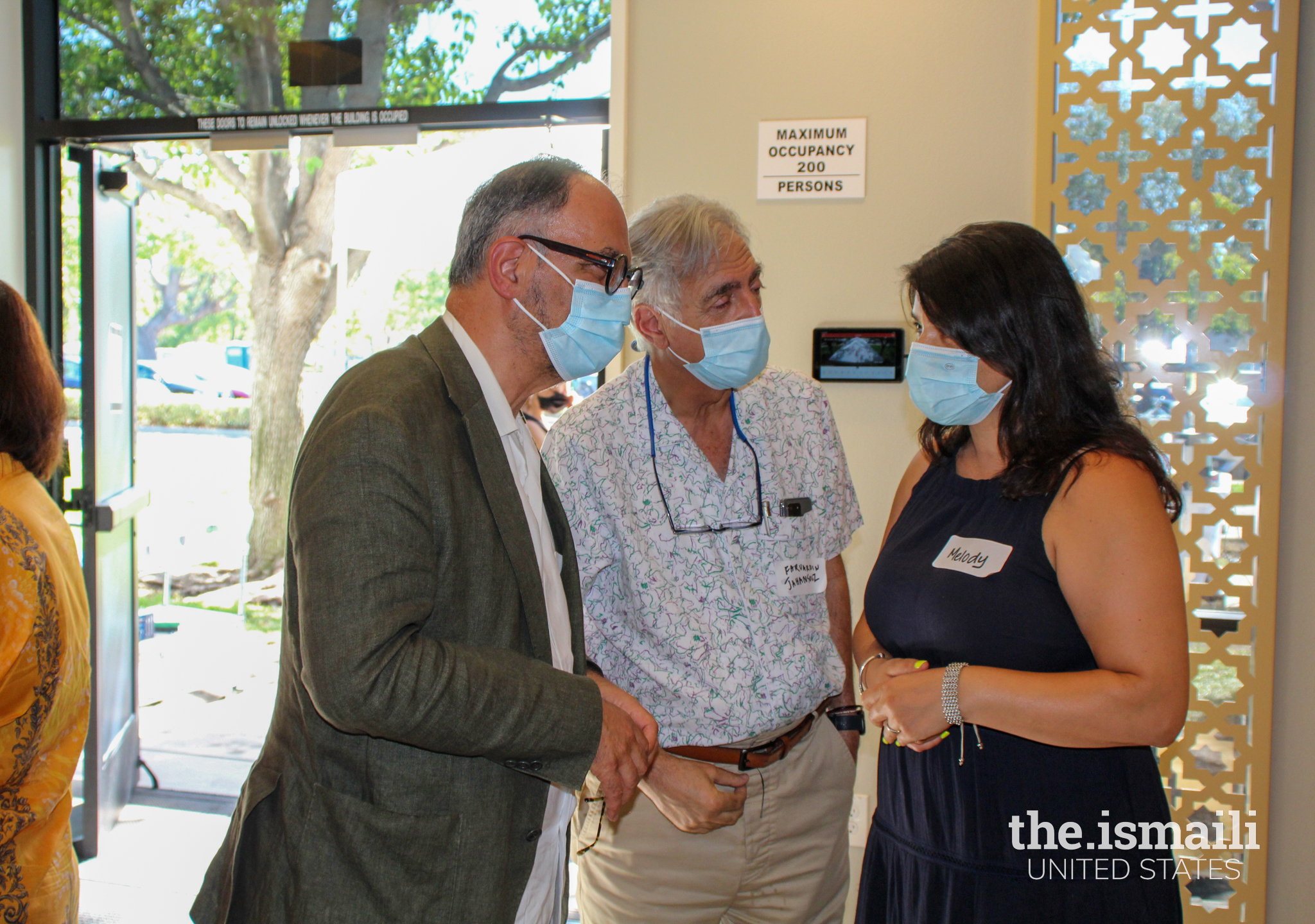 Dr. Derakshani with guests at Milpitas Jamatkhana viewing the AKAA exhibits