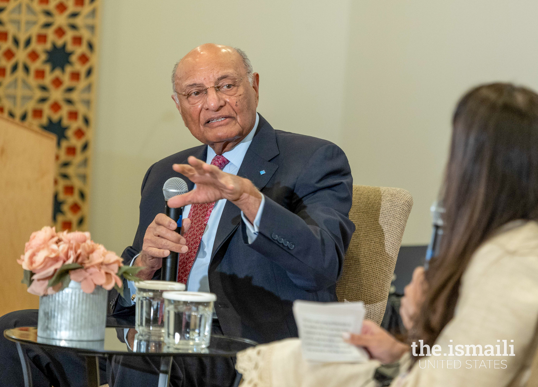 Dr. Lakha addressing Chairman Mehreen Ghaswala during an  ongoing discussion.