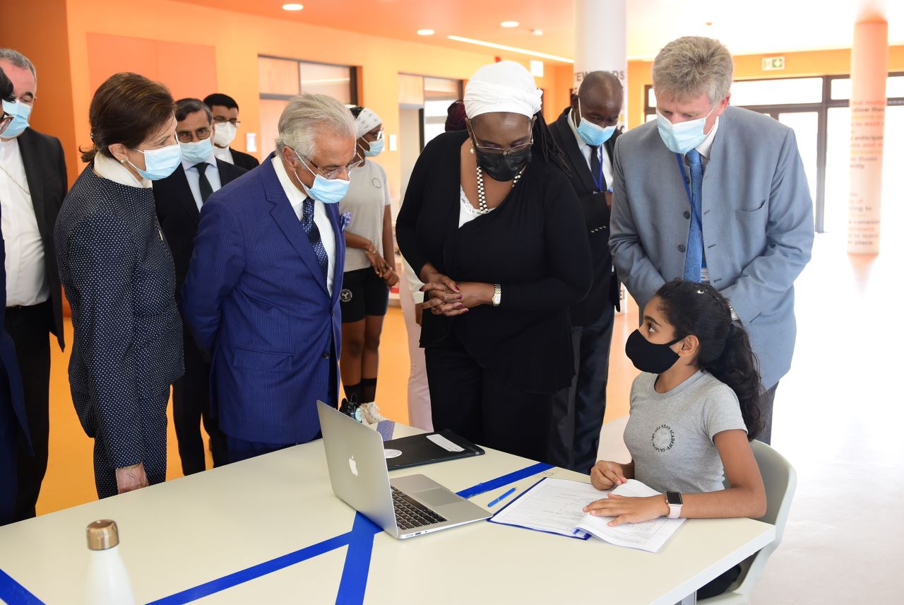 Moment of interaction between the Minister of Education and Human Development Rita Carmelita Namashulua with a student, accompanied by the Diplomatic Representative of the Aga Khan Development Network Nazim Ahmad (left in the photograph) and the Director of the Academy Michael Spencer (right in the photograph) at Aga Khan Academy Library.