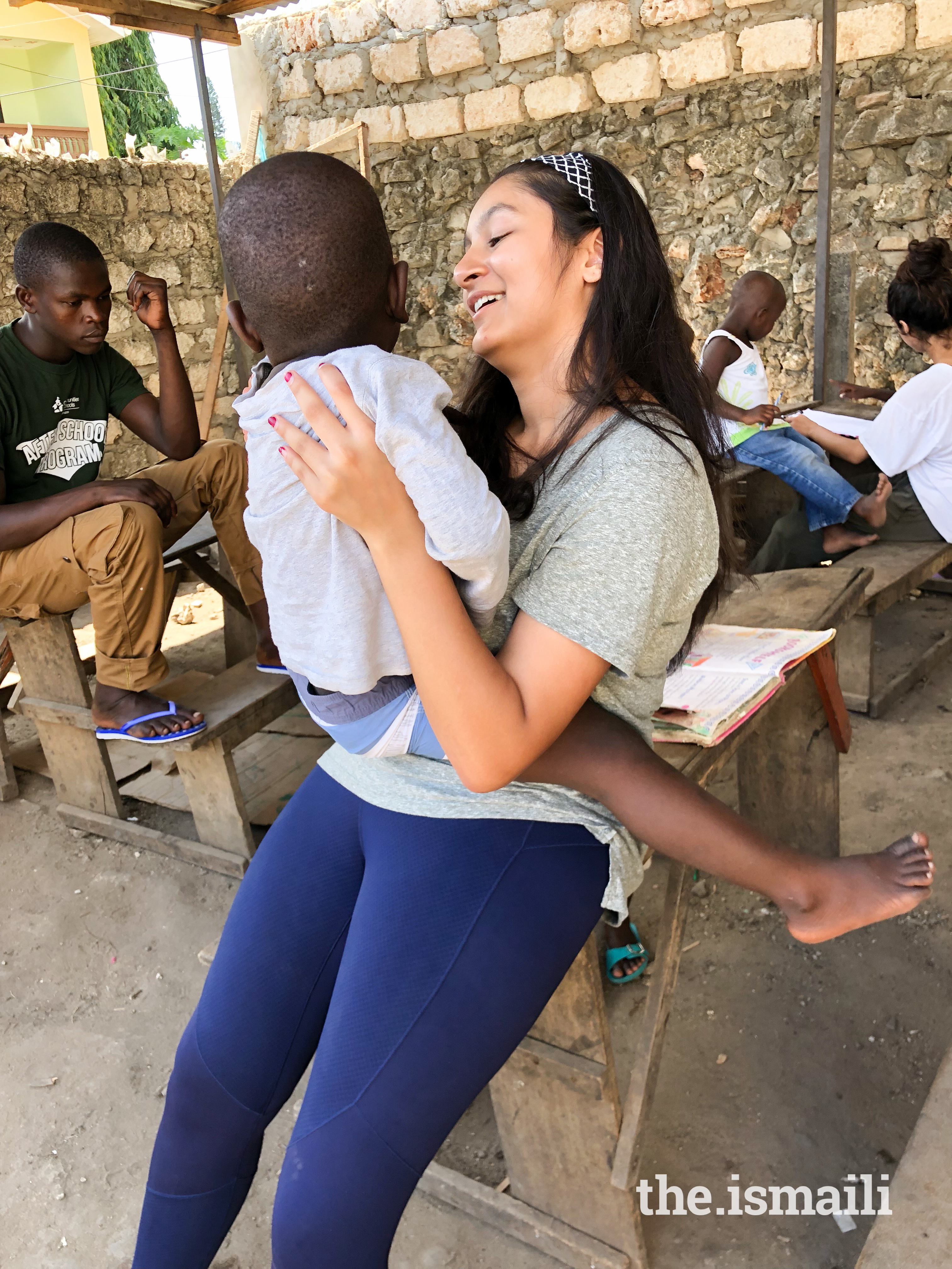 Sarah Ali at Global Encounters in Kenya playing with a child.