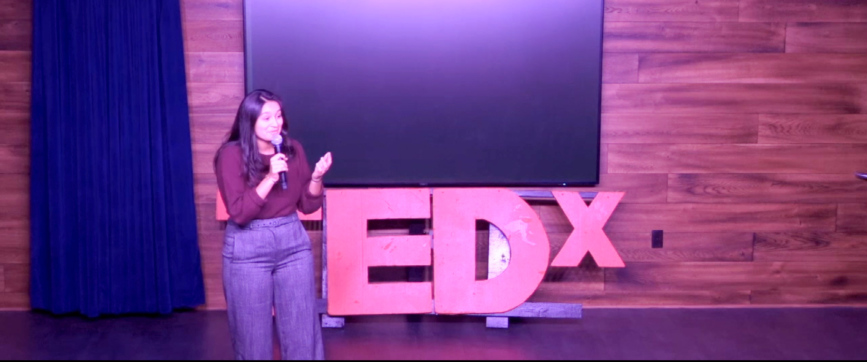 Sarah Ali delivering her TEDx talk.