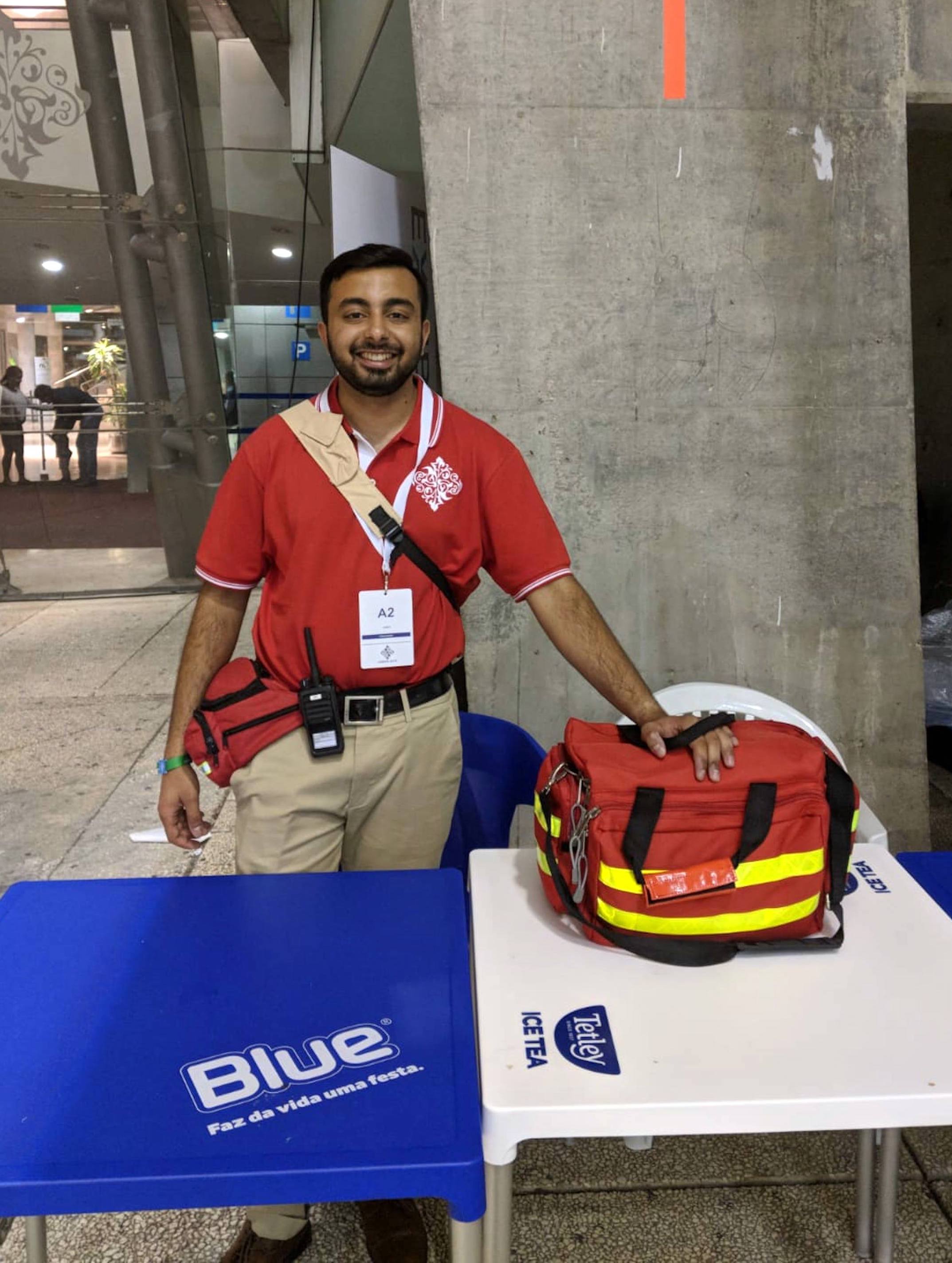 Altamish Daredia volunteering at a medical desk in Lisbon during the Diamond Jubilee Celebration in 2018.