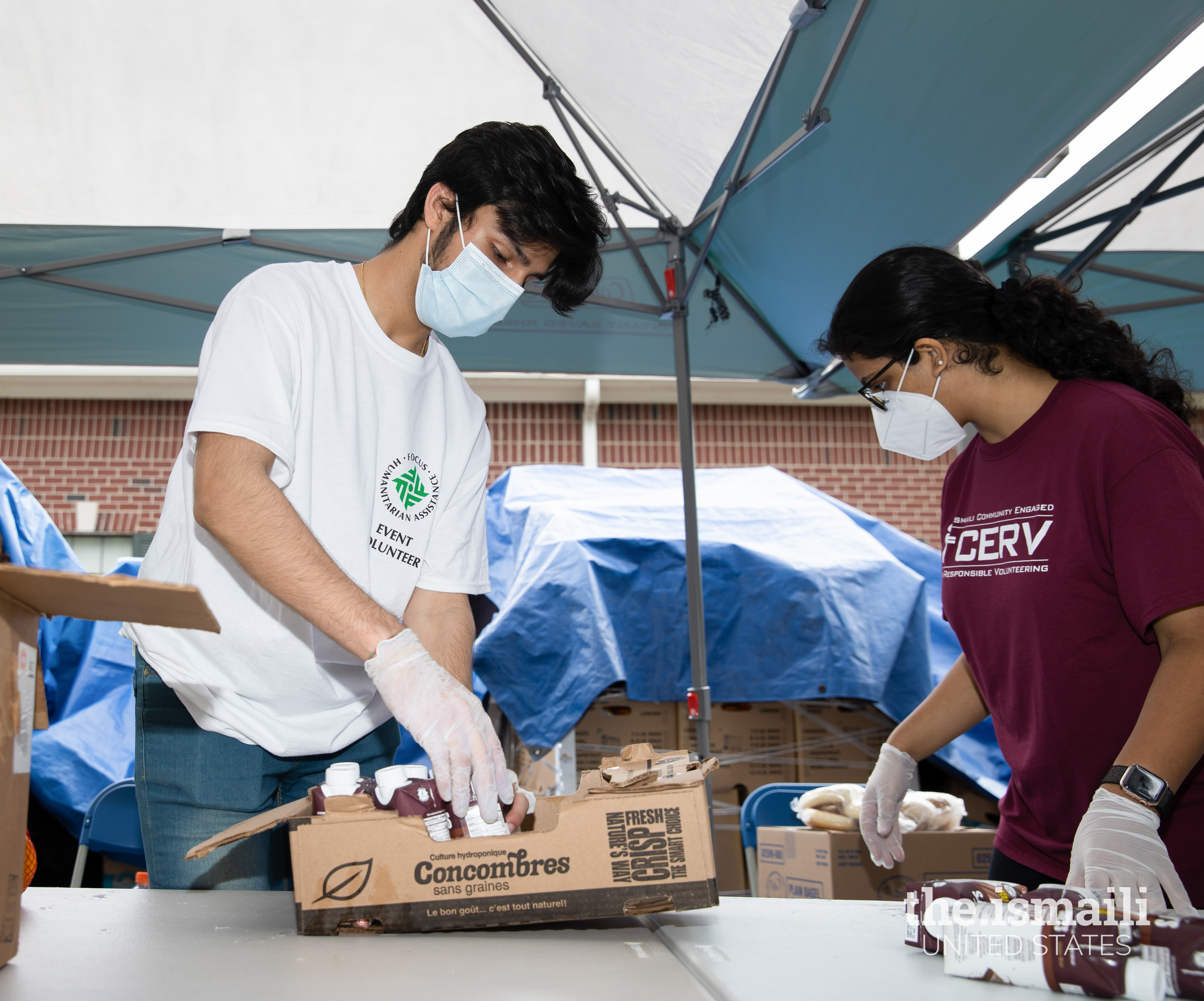 Volunteers packing boxes of food for families who are suffering from food insecurity as a result of the economic effects of the COVID-19 pandemic.