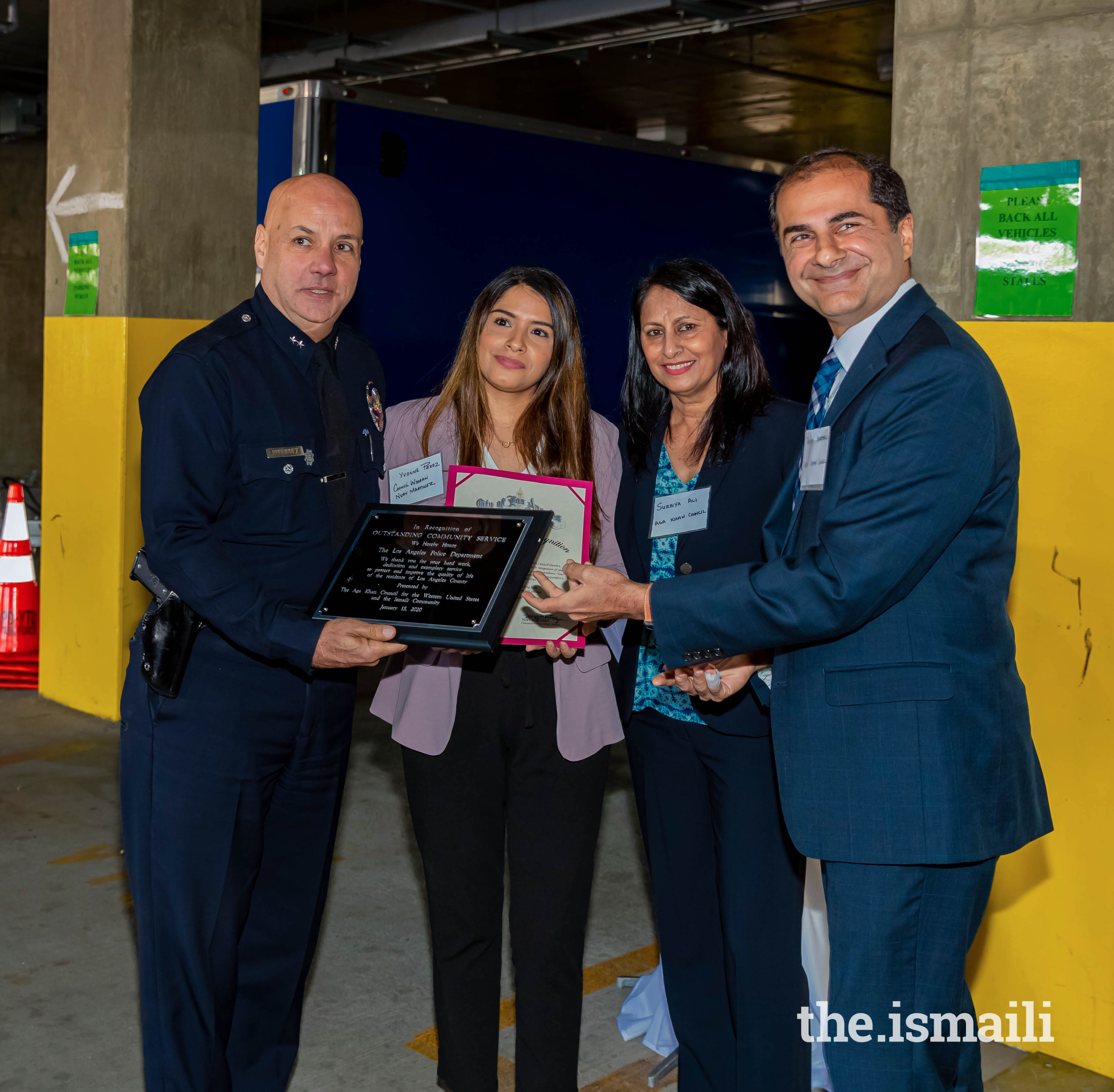 President Rahim Karmali and Yvonne Perez from the office of Nury Martinez, President of Los Angeles City Council, presenting an award to the Deputy Police Chief Jorge Rodriguez.