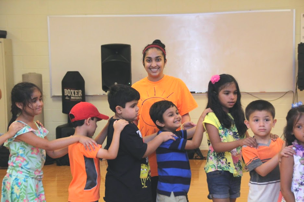 A Group Guide begins to transition her group from assembly to swimming.