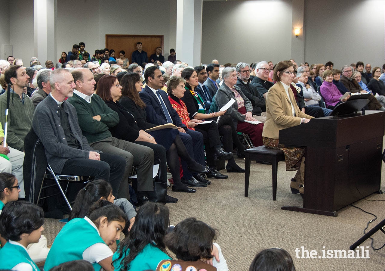 Interfaith leaders and guests of Edgewater Community Religious Association attending the Thanksgiving gathering at the Chicago Jamatkhana Social Hall. The Ismaili Girl Scouts are seated in the front. 