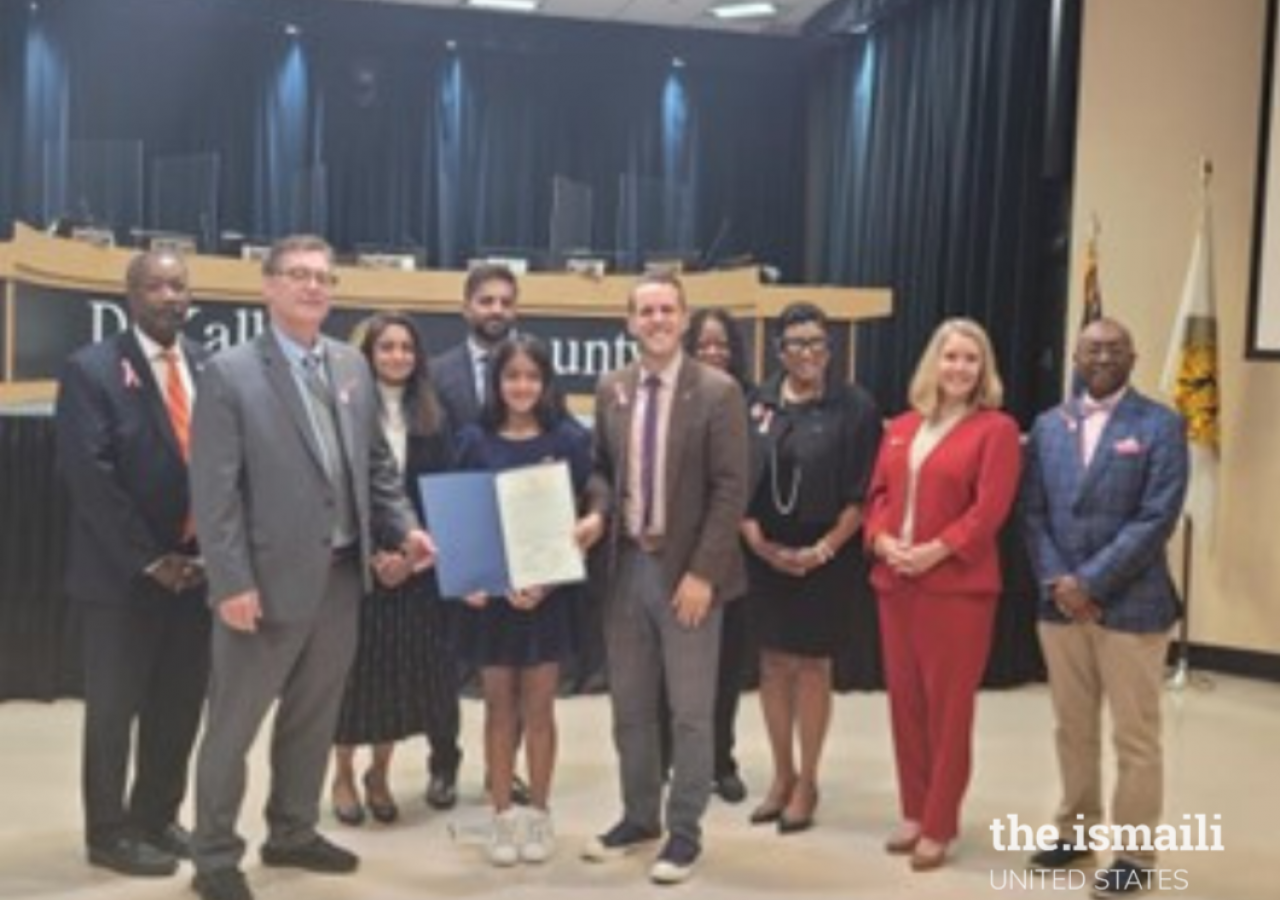 Sufi Mmomin with the DeKalb County Board of Commissioners when she received her proclamation. 