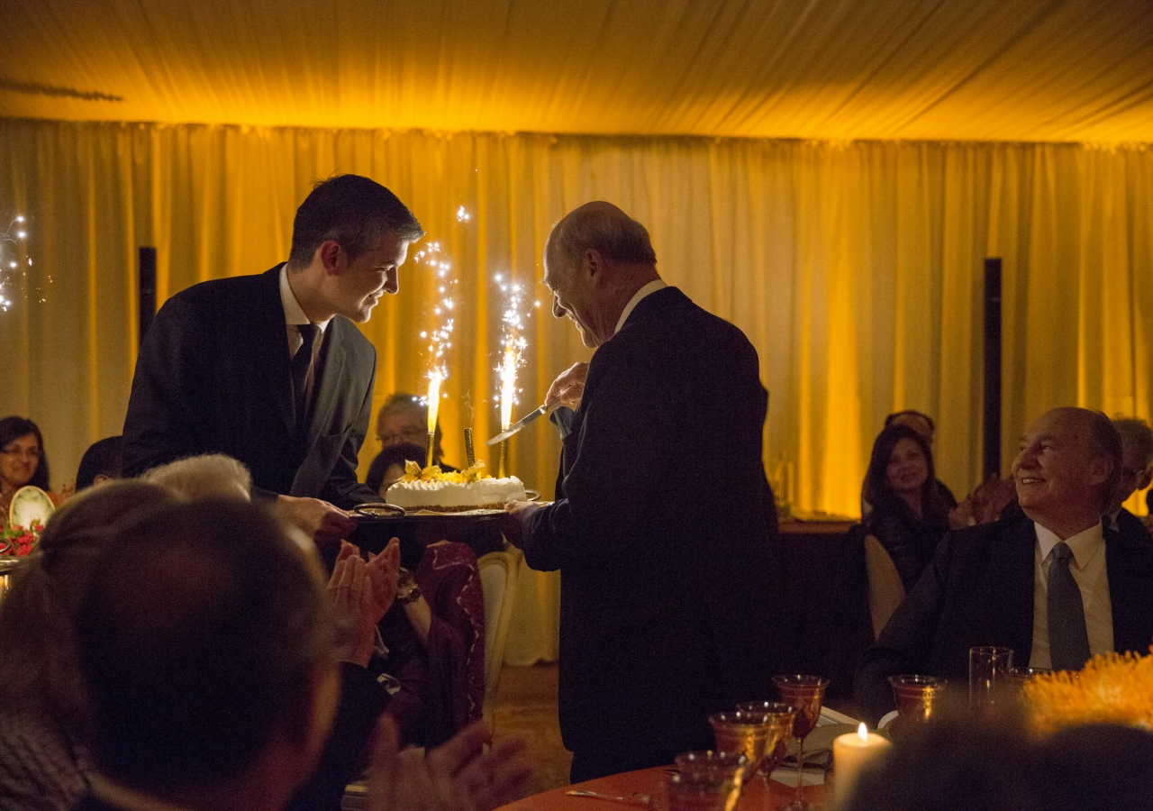 Prince Amyn cuts his birthday cake, as Mawlana Hazar Imam looks on.