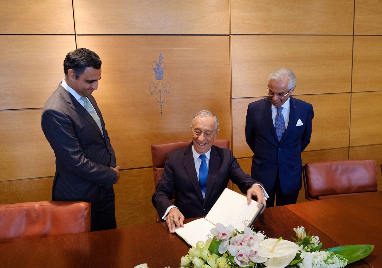 President Marcelo Rebelo de Sousa signs the visitor&#039;s book at the Ismaili Centre, Lisbon, with Ismaili Council President Rahim Firozali and Ismaili Imamat Diplomatic Representative Nazim Ahmad looking on.