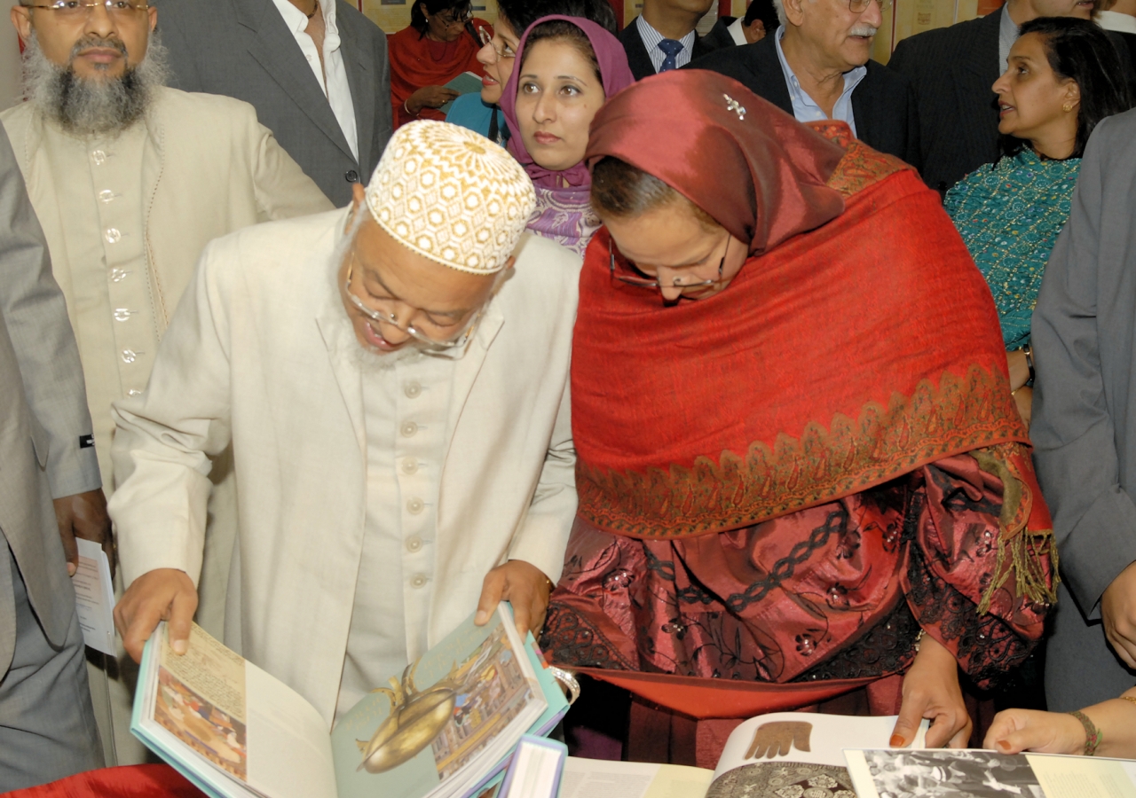 Attendees at the book launch event examine copies of “The Ismailis: An Illustrated History.” 