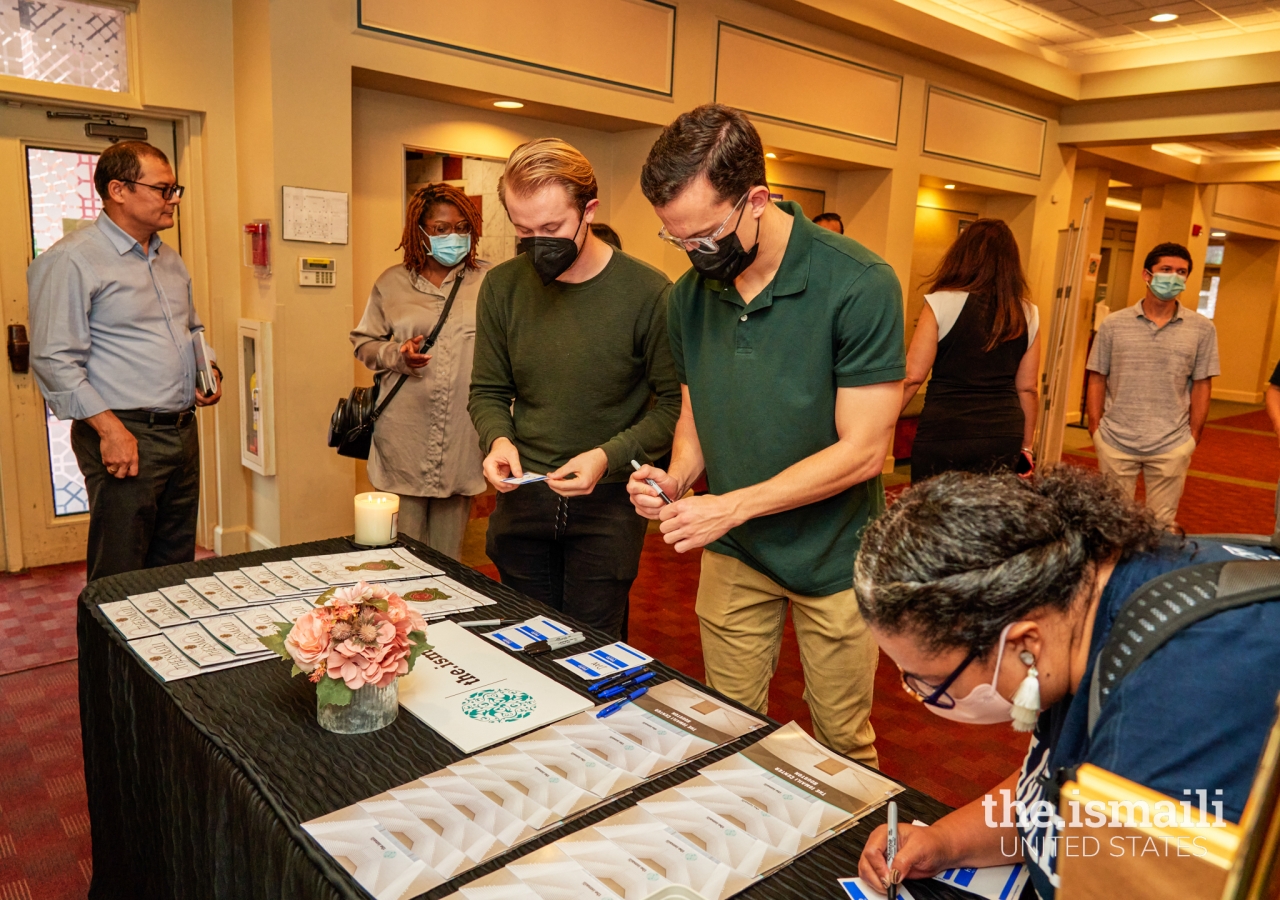 Emory University School of Theology students check in as they arrive for Dr. Asani’s lecture at the Ismaili Jamatkhana in Decatur.