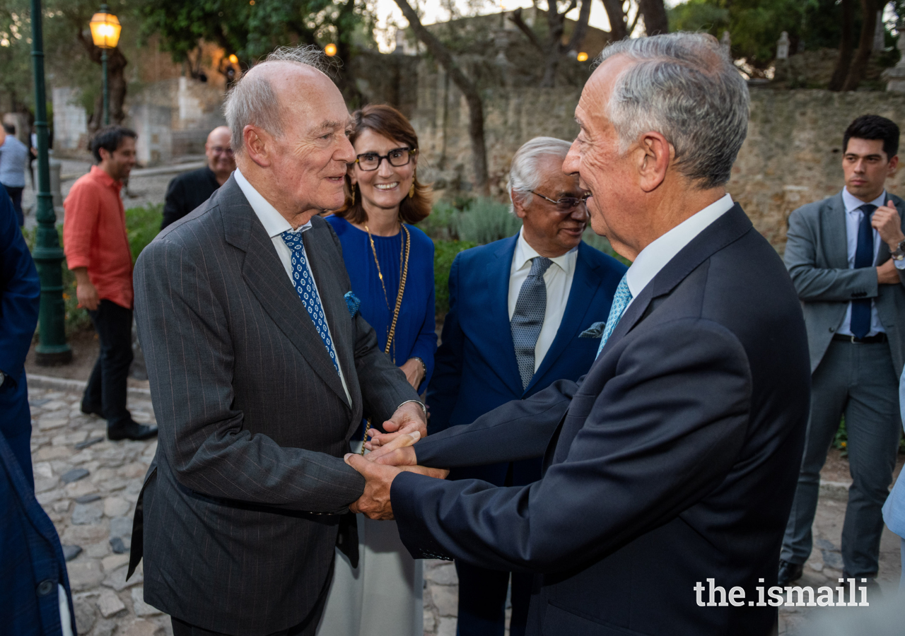 Prince Amyn welcomes President Marcelo Rebelo de Sousa to the Aga Khan Master Musicians concert at Castelo São Jorge on 8 July 2022, as Minister of Justice Catarina Sarmento e Castro looks on.