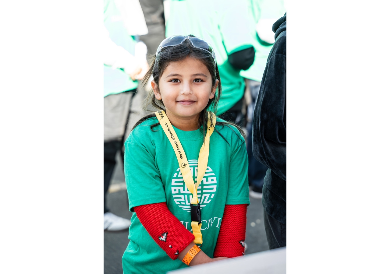 A young Ismaili CIVIC volunteer ready to start a day of tree planting on a brisk fall Sacramento day