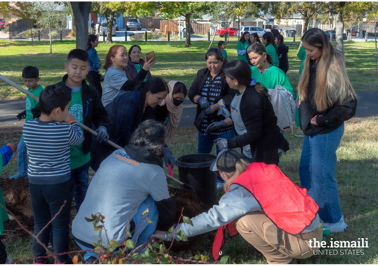 Ismaili CIVIC volunteers of all ages come together in a shared effort to plant a tree, fostering teamwork and a commitment to creating a greener future.