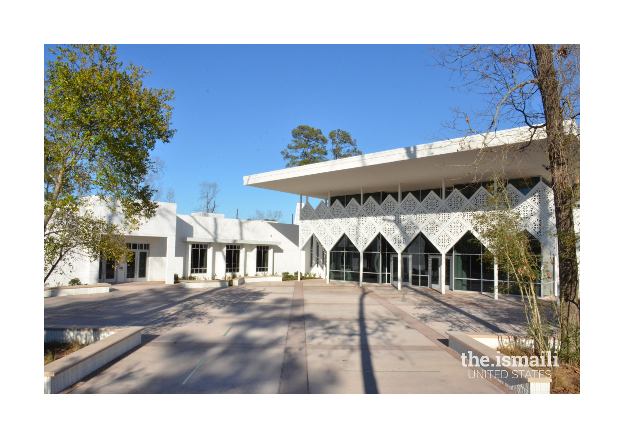 A view of the main courtyard, Jamatkhana entrance (canopy and doors pictured on the right), social hall entrance. The main courtyard space and canopy in front of the main entrance are part of an architectural design referred to as the Mission Style.