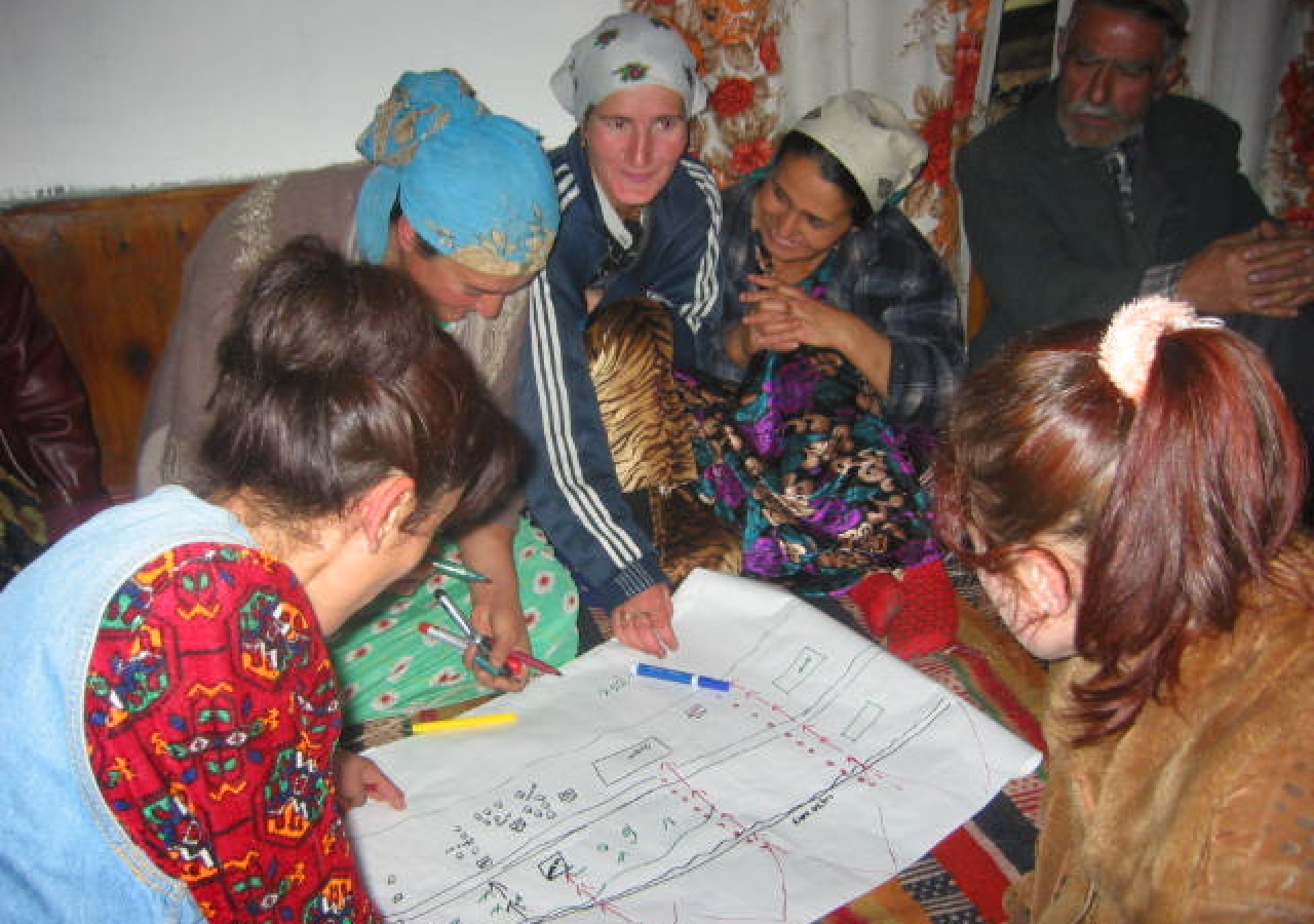 In the Ghund Valley of Shugnan district in 2004, community members engage in a mapping exercise to gauge their preparedness for potential disasters. 