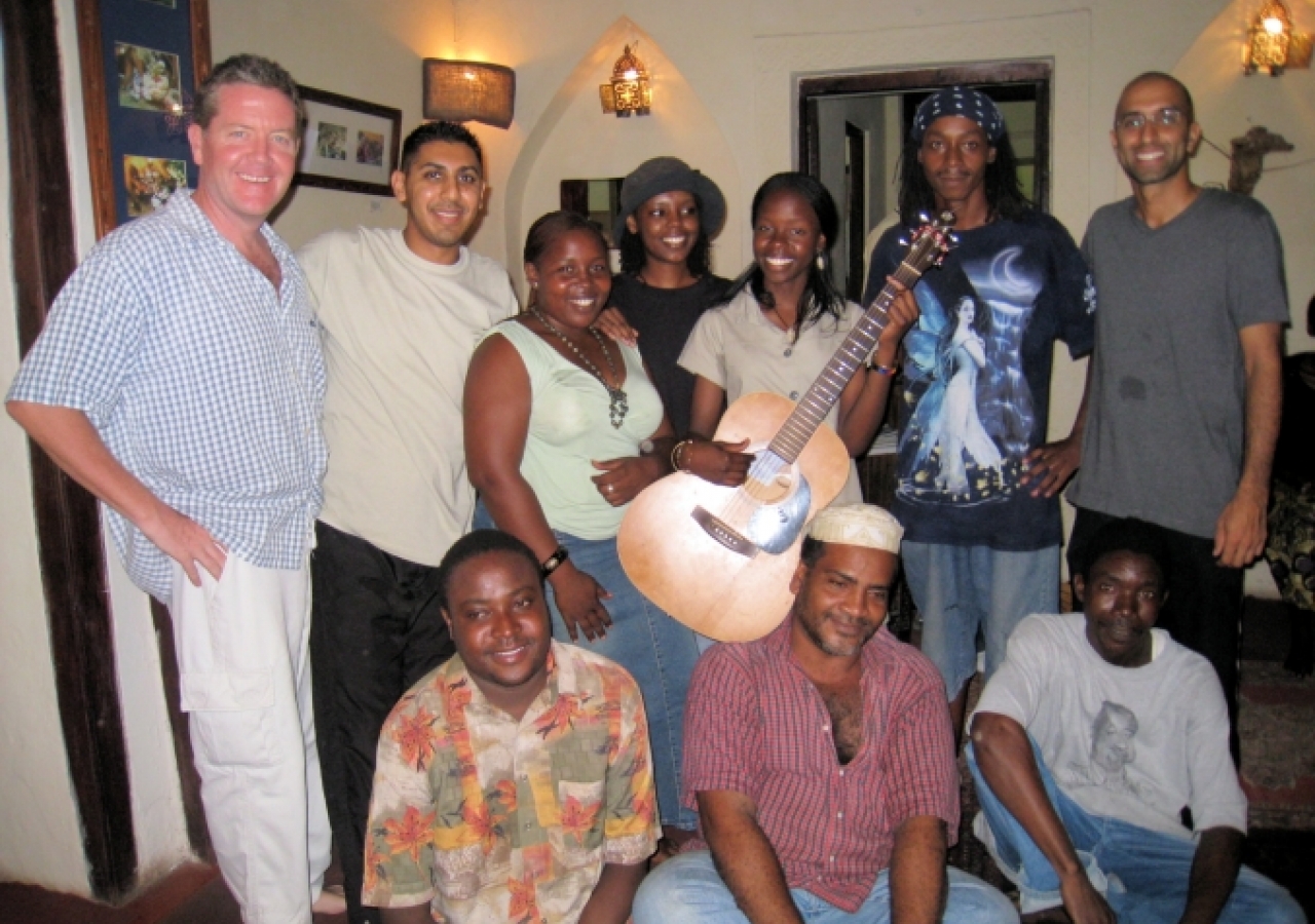 After a performance, the Jahazi Coffee House family gathers with an afro-fusion gospel singer and guitarist from Nairobi.