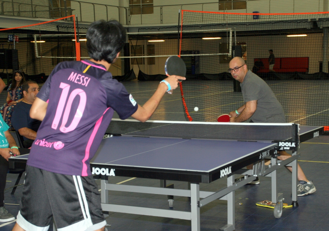 An intense game of table tennis, as President Shahjahan reaches to return the ball