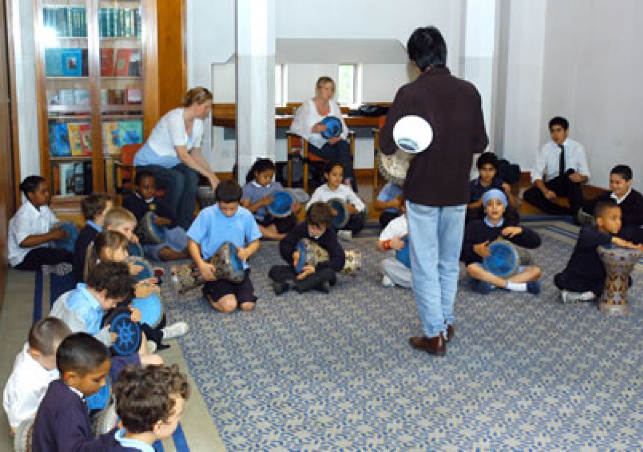 School children learn to play the daf, an Iranian percussion instrument 