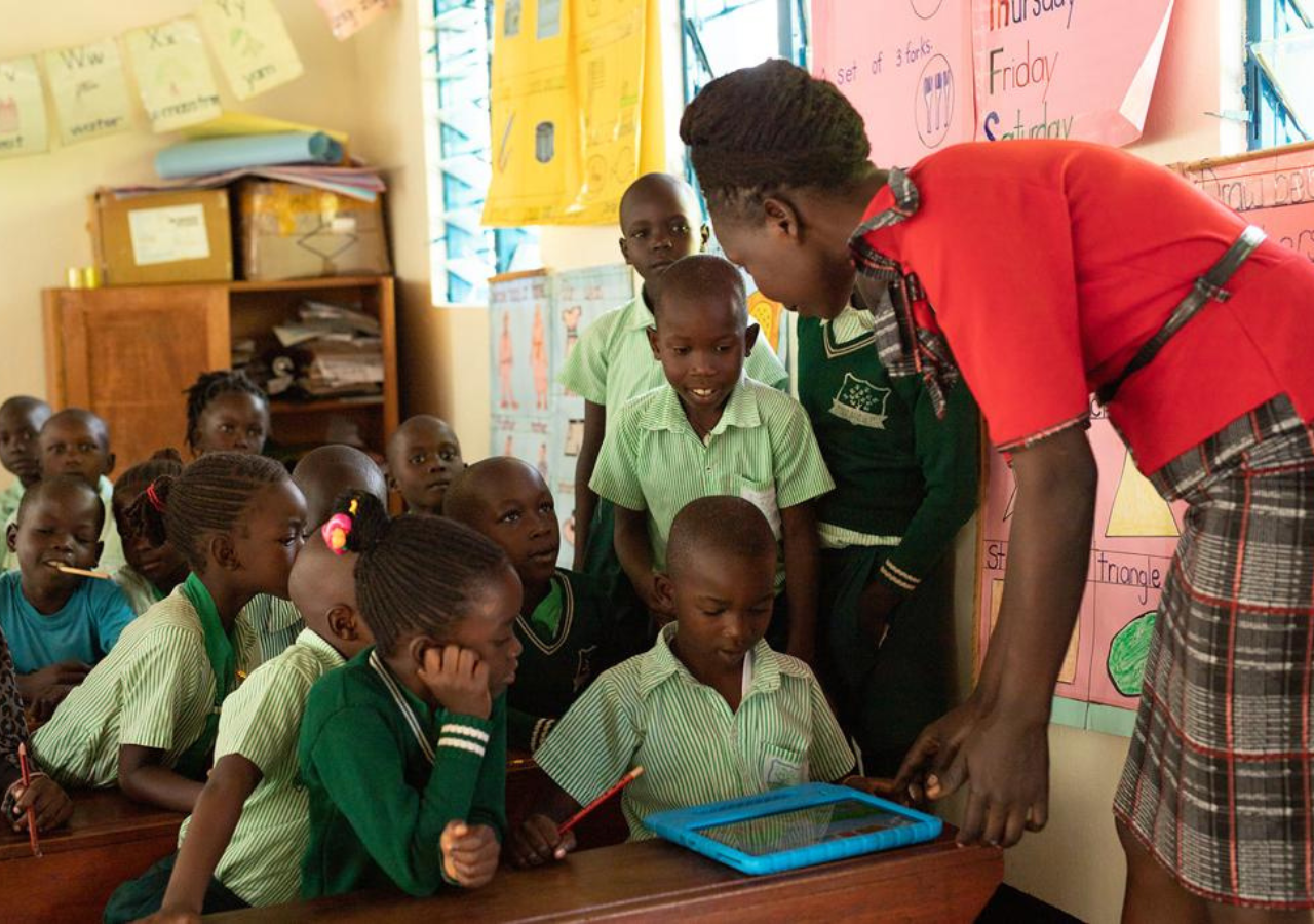 Students gather around a tablet computer at Project Shelter Wakadogo in northern Uganda.