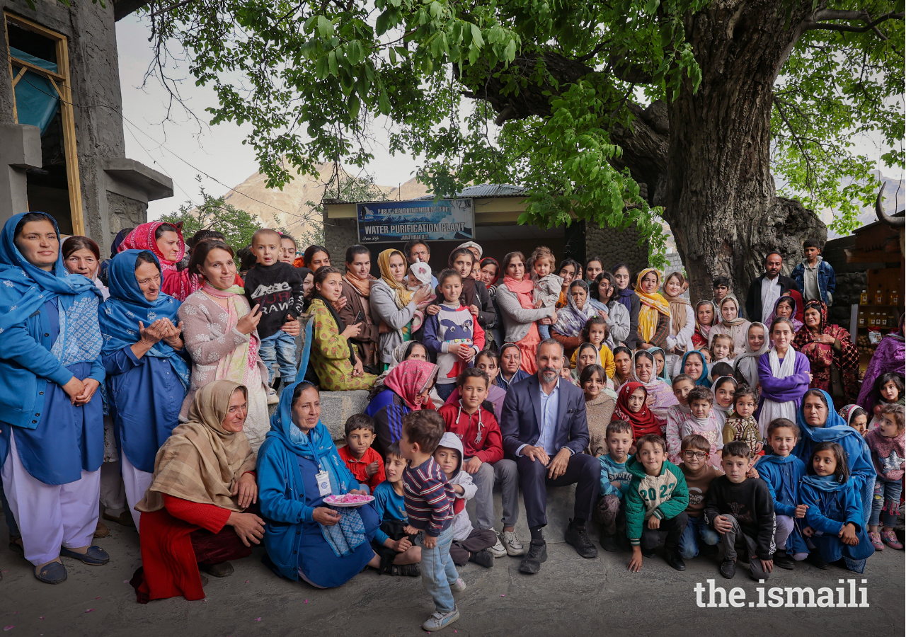 Prince Rahim poses for a photograph with members of the Jamat, many in Ismaili Volunteers uniform, as he walks around the Altit Fort area.