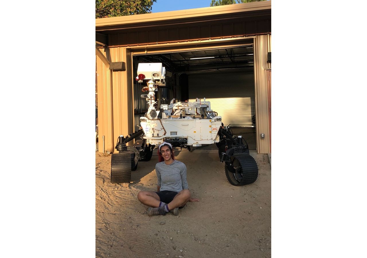 Farah Alibay in NASA’s Jet Propulsion Laboratory's Mars Yard with Perseverance's twin, OPTIMISM, which is used for testing on Earth.