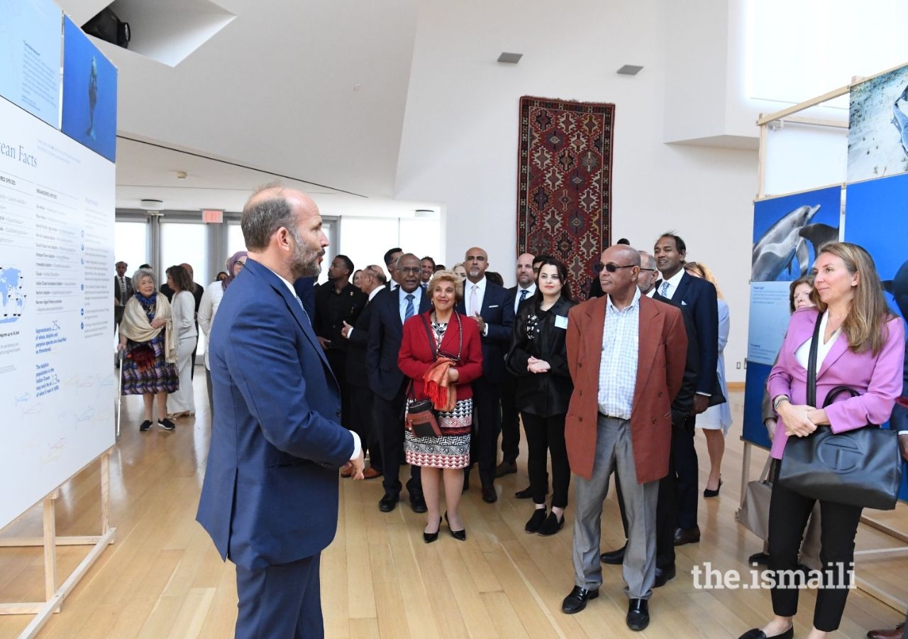 Prince Hussain takes guests through his exhibition, highlighting memories from his underwater explorations.