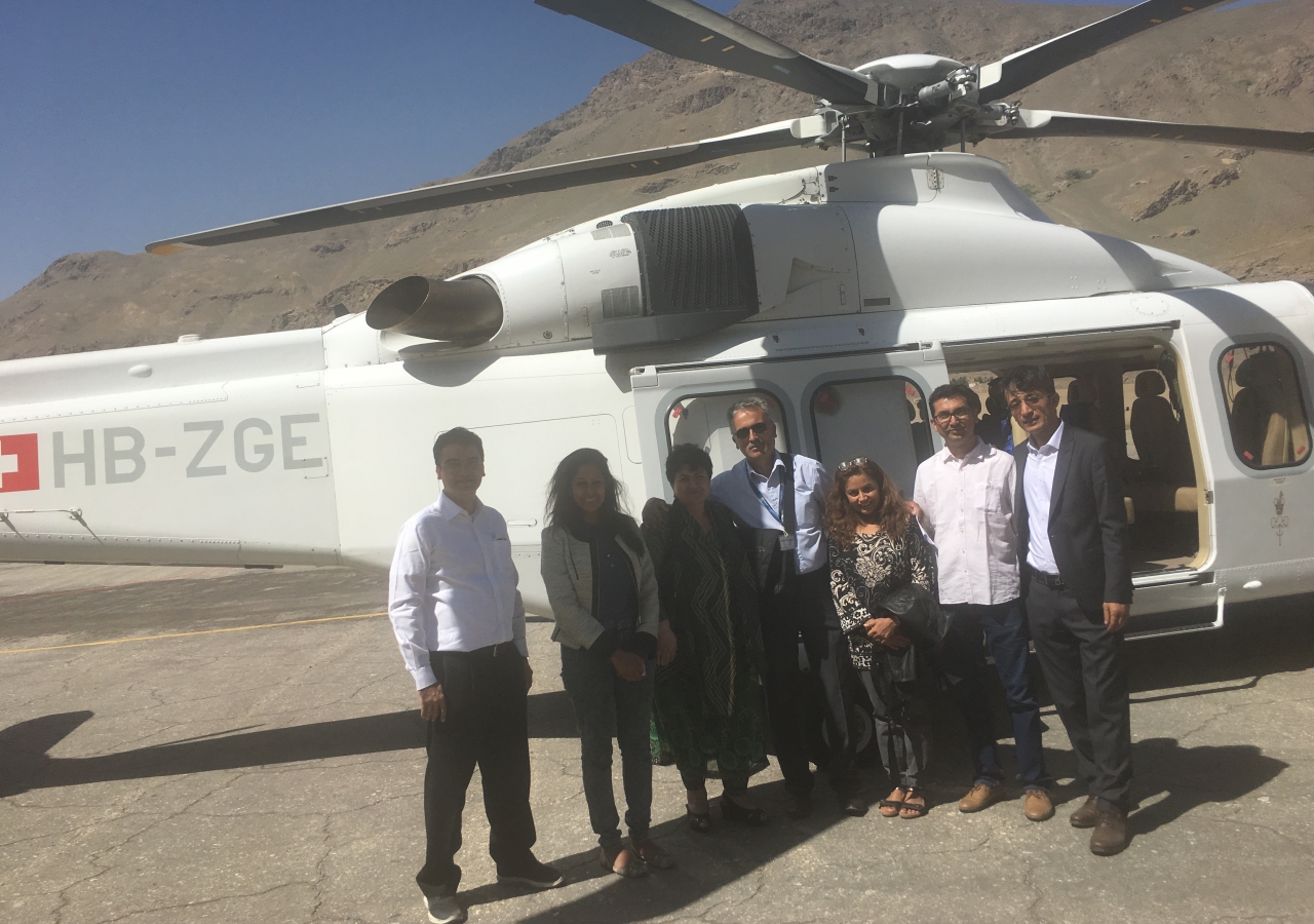 Global QoL Core team arriving in Khorog. From left to right: India Council President Ashish Merchant; Shazmin Dosani, DJI; Former Tajikistan Council President Sharofat Mamadambarova; Helicopter Pilot; Dr. Seema; AKEB India Chairman Aslam Hirani; and Afghanistan Council Vice President Hadi Alizadeh