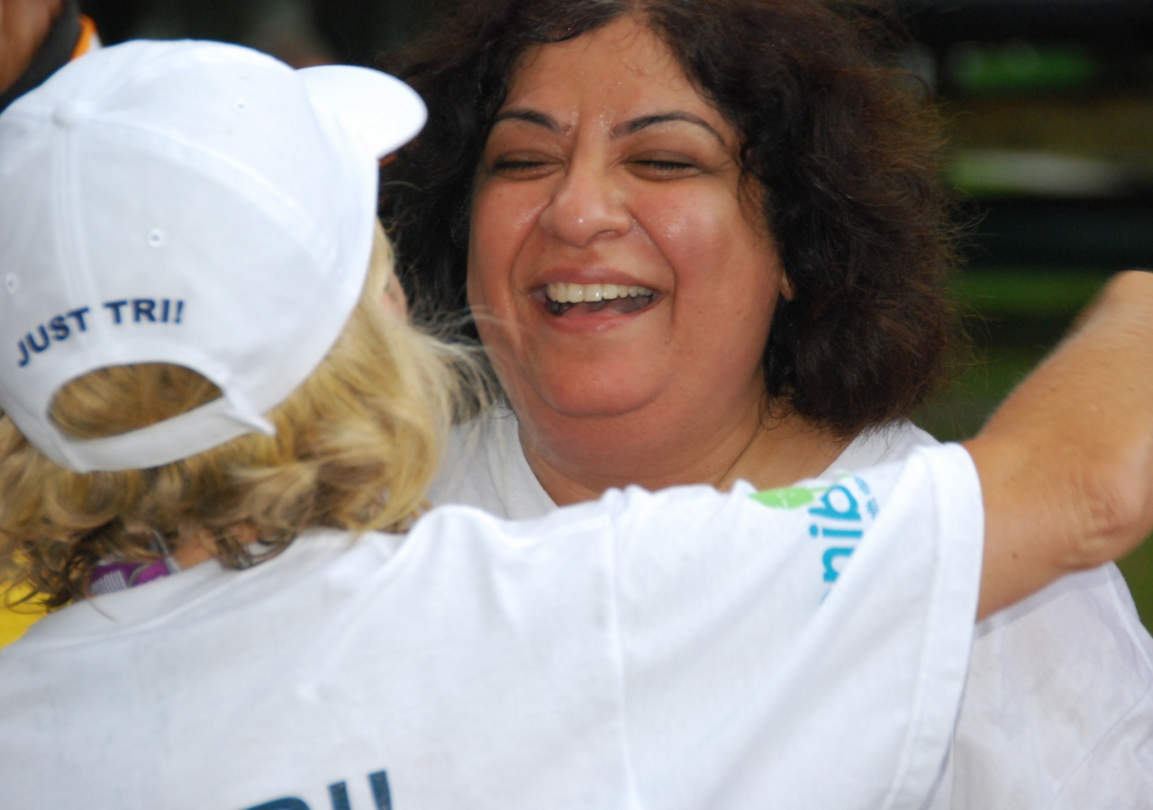 Rozina Issani receives a warm embrace from a fellow team member.