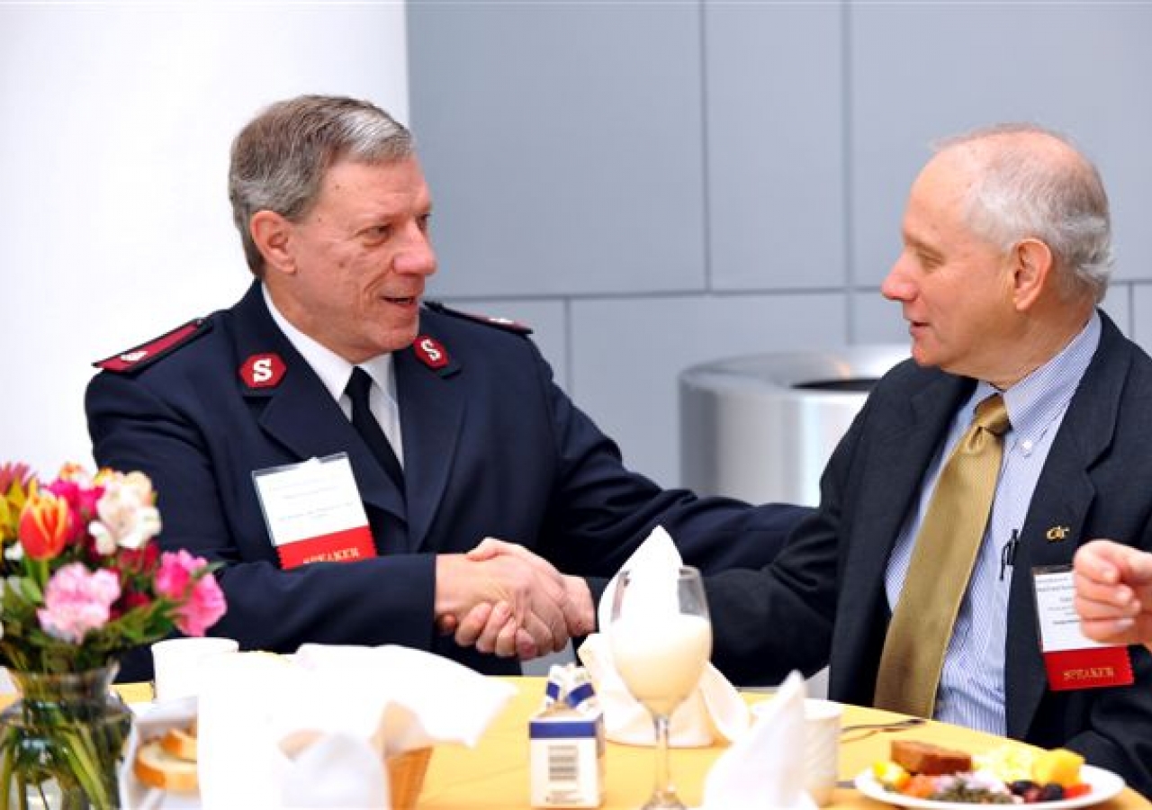 Major George Polarek, Assistant Executive Director of The Salvation Army World Service Office, and Gary Schuster, Provost of Georgia Tech shake hands at the Dignitary Breakfast sponsored by FOCUS.