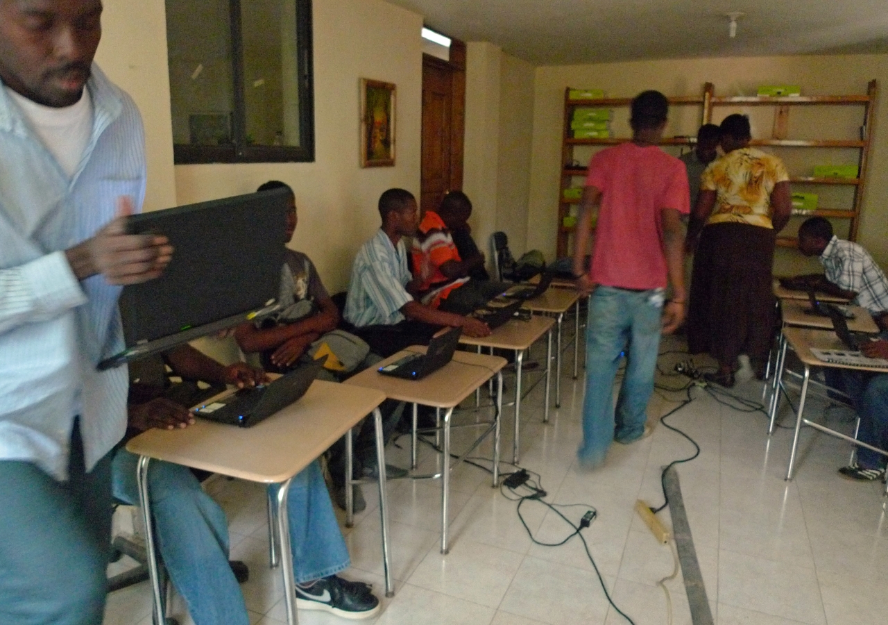 Workers during a training session in Haiti with laptops procured by Samasource.