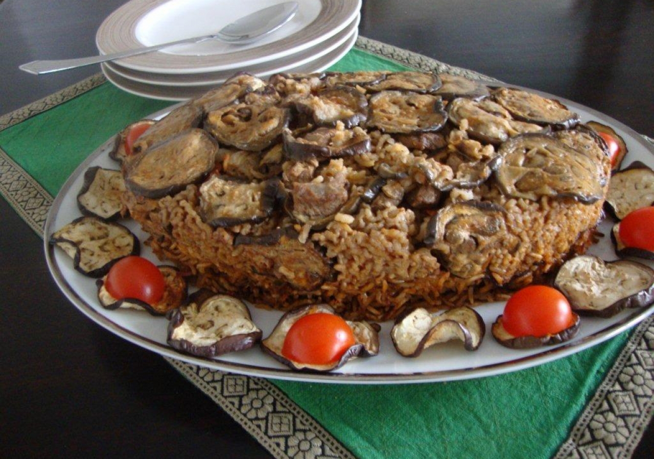 Mkluba is a Syrian dish of layered meat, aubergines and rice, cooked in a tomato flavoured sauce.