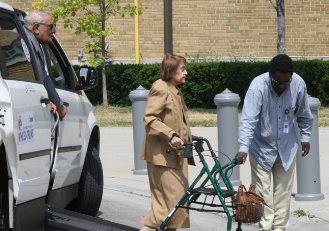 A volunteer assists seniors arriving at the Direct Energy Centre in Toronto for the day’s events and celebrations.