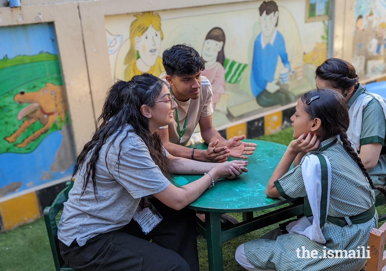 Global Encounters Camp participants, Iman Ladhani (Australia) and Armaan Sumar (Kenya), speaking with students from the Sultanabad Community Based School (CBS). Global Encounters Camp participants partnered with students and teachers from the Sultanabad CBS on their service learning project. 