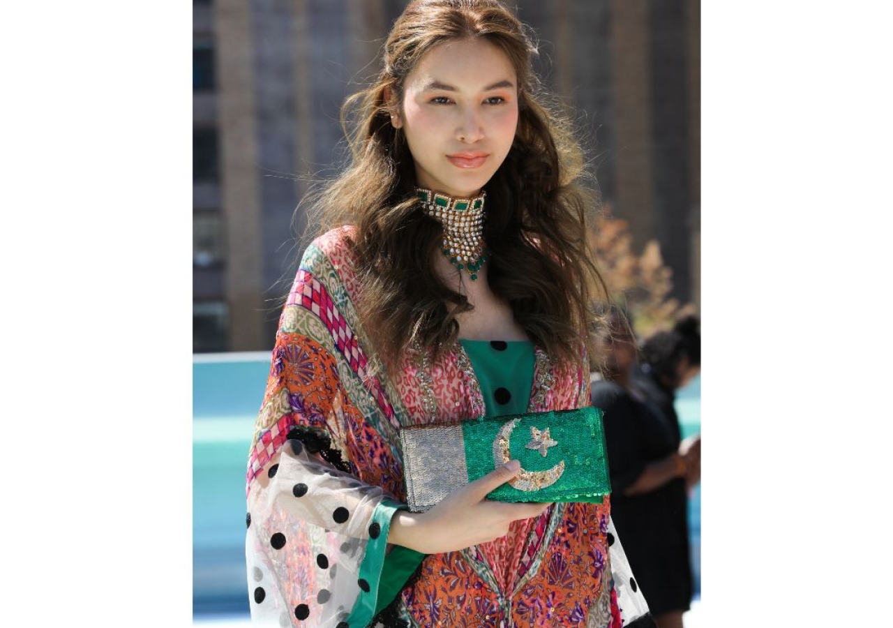 A NYFW model depicting the quintessential Ashraf as a designer. An amalgamation of print, texture, and silhouette. The handmade clutch with sequins represents the Pakistani flag.