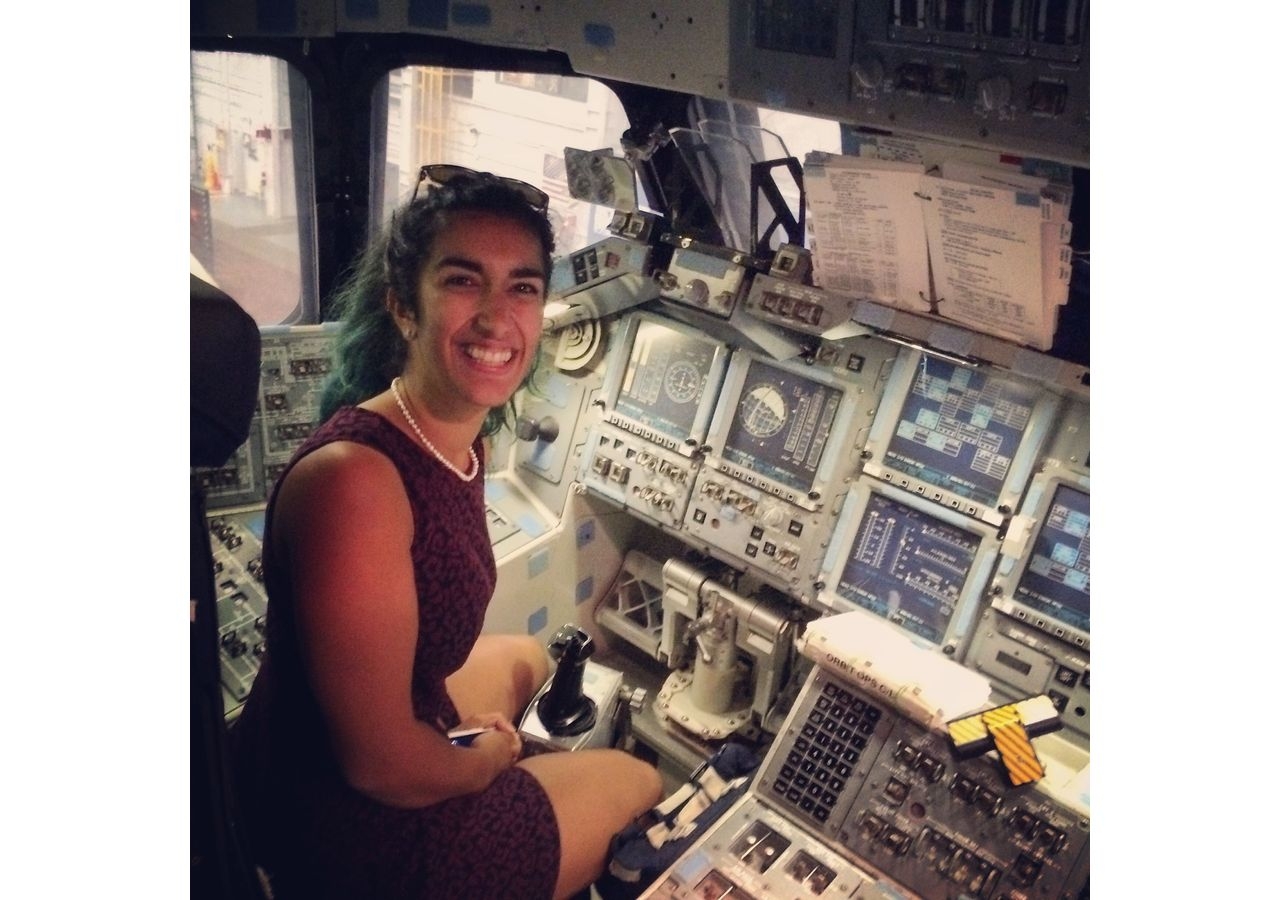 Farah sitting in the space shuttle simulator during a trip to NASA's Kennedy Space Center.