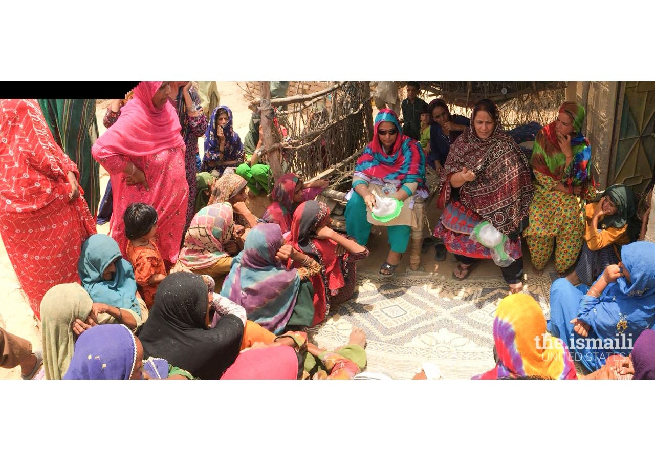 Fatima Khuwaja-Karim, a volunteer of KWA, conducts a session with women and children of Jungshahi village about the importance of education and hygiene.