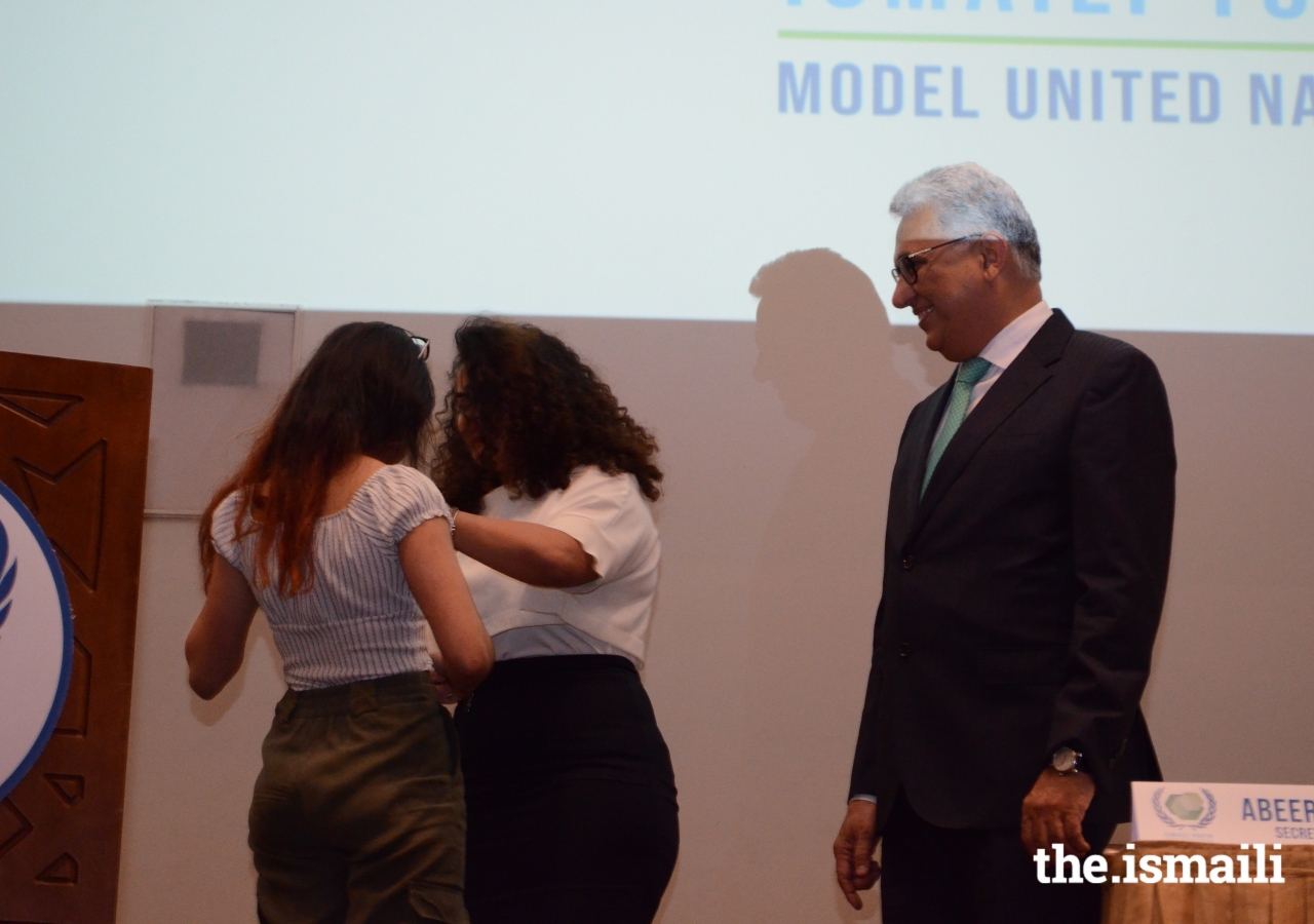 President Amiruddin Thanawala and IYMUN team member, Asma Lakhani badge the appointed Student Officers for the 2019 conference