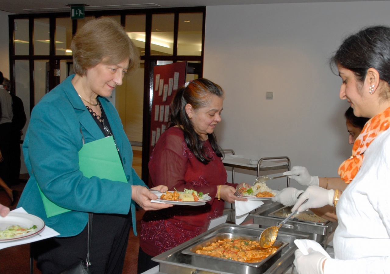 Dr Rowan Hillson, National Clinical Director for Diabetes, samples a healthy version of Chicken Tikka prepared from a Nutrition Centre recipe.