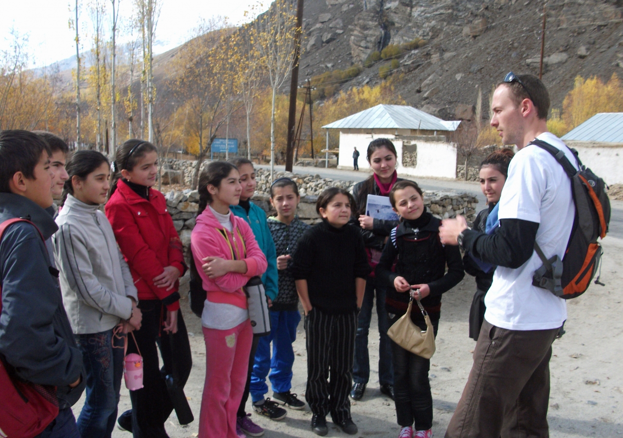 Students listen intently to Robert White — a Fulbright Fellow from the United States working with the Unviersity of Central Asia in Khorog — as he introduces them to rock climbing ahead of a group hike that was part of their weekend orientatio