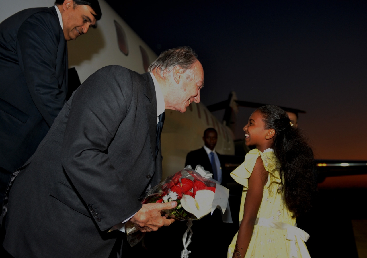 Mawlana Hazar Imam is presented with a bouquet of flowers upon his arrival at Julius Nyerere International Airport in Dar es Salaam.