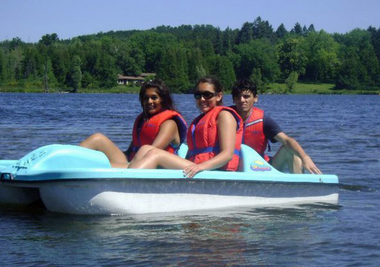 Al-Ummah participants enjoy a sunny day in a paddle boat on the lake.