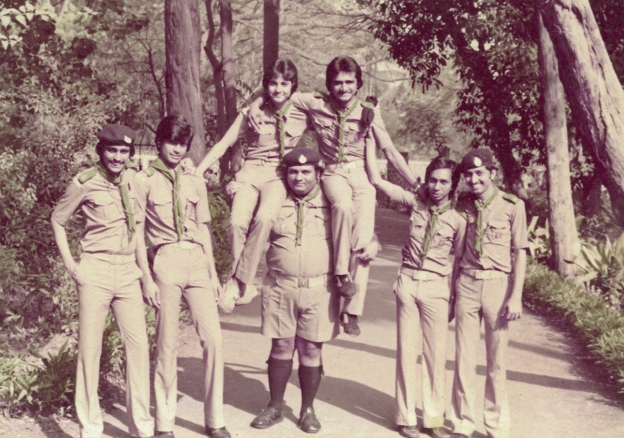 Karim Moledina (centre) enjoys a picnic with the Rovers of Darkhana Scout Group. In 2011, Moledina marked 50 years with the Scouts movement.