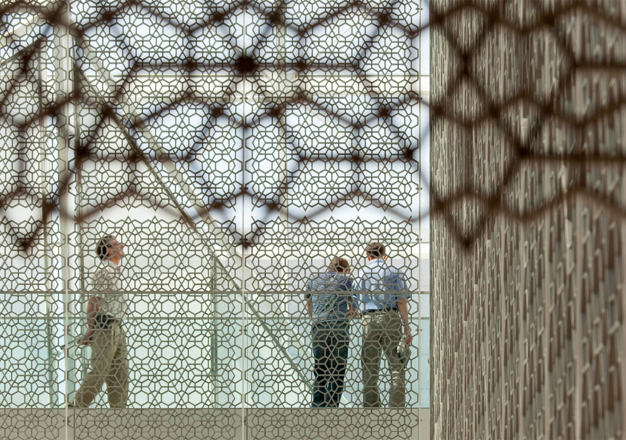 People seen through the mesh of the jali screen at the Delegation of the Ismaili Imamat in Ottawa.