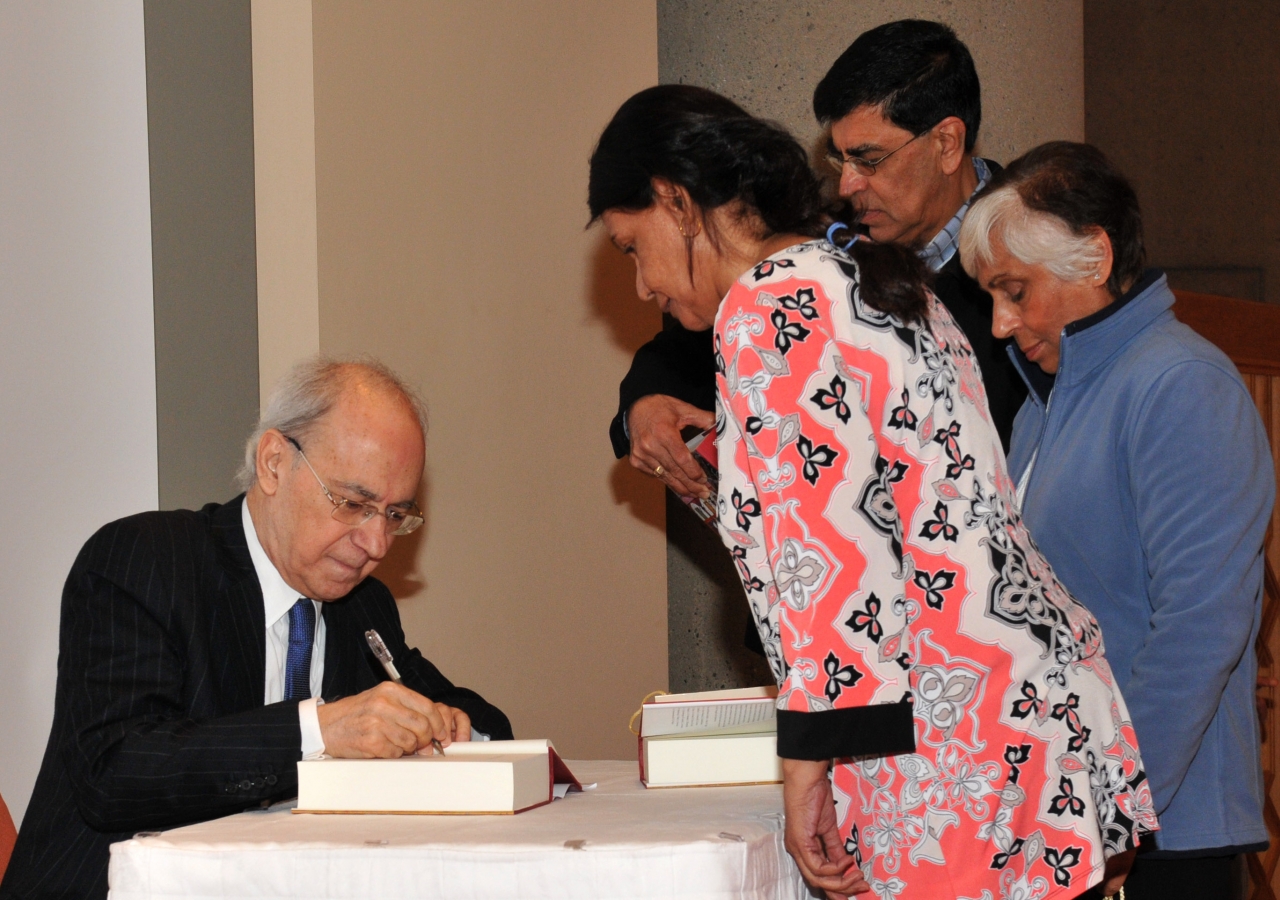 Dr Farhad Daftary signs copies of the publication "Fortresses of the Intellect" at the Ismaili Centre, Burnaby.